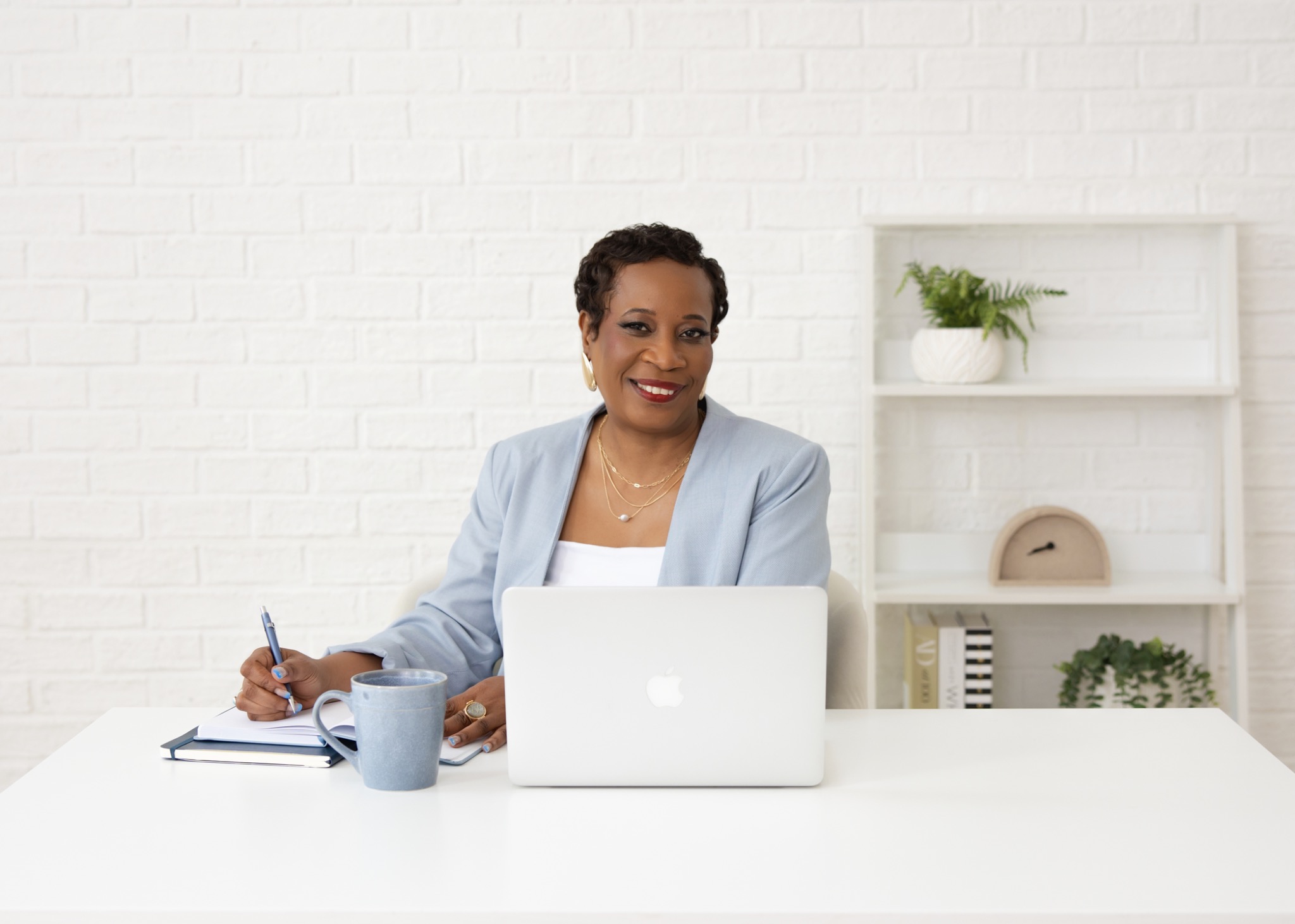 Narda Brown, founder and principal consultant, seated at her desk